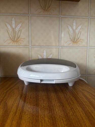 a white toilet in a room with a wall at ALAMEDA iNN in Poços de Caldas