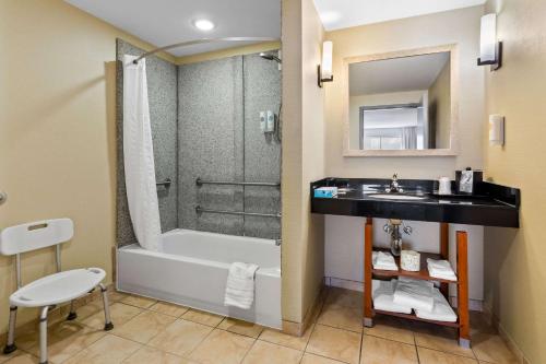 a bathroom with a tub and a sink and a shower at Comfort Suites Salem-Roanoke I-81 in Salem