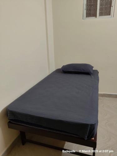 a bed in a room with a black mattress at Adithya Inn Lodge in Jadcherla