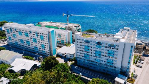 an aerial view of a large building next to the ocean at Perfect Staycation in Duma -Marina Spatial Condo in Dumaguete