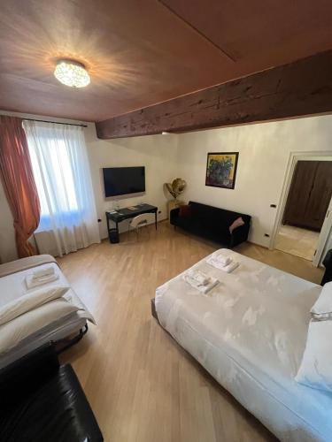 a bedroom with a large bed and a couch at Casa Nina Bologna Centro in Bologna