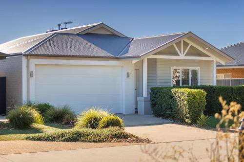 a house with a white garage at Luxury Golfers Escape Yarrawonga in Yarrawonga