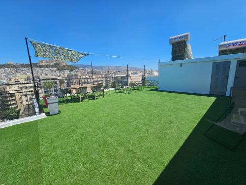 a patio with green grass on the roof of a building at Lycabettus View Kaniggos in Athens
