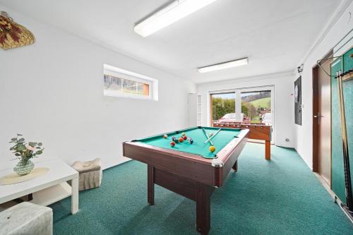 a living room with a pool table in it at Chalupa Pod Studánkou in Petříkovice