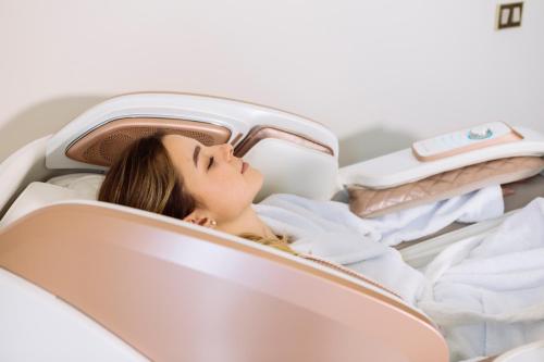 a woman laying in a bed in a car at Easy Green Hotel in San Giovanni Rotondo