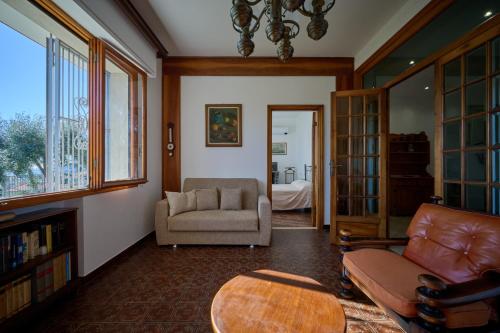 a living room with a couch and a chair at Villa Camilla Appartamento Giardino in Diano Castello