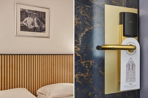 a room with a bed and a door with a picture at Hotel Gabriel Issy Paris in Issy-les-Moulineaux