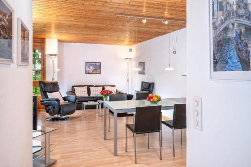a living room with a table and chairs at Familienunterkunft Schweizerhof 414 - Lenzerheide in Lenzerheide