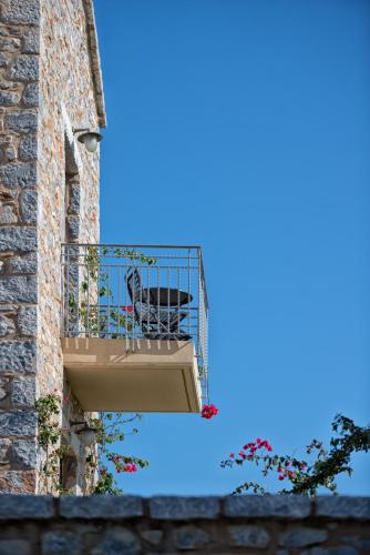 a bird sitting on a balcony of a building at Castello Antico Hotel in Gythio