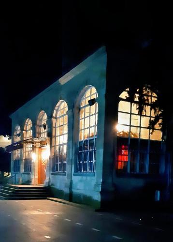 a blue building with large windows at night at Samlife Apart in Samsun