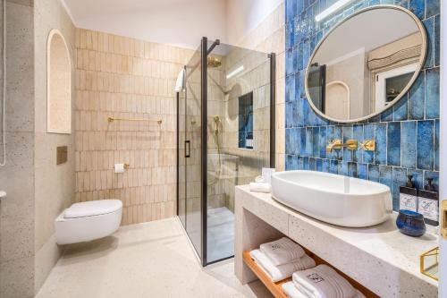 a bathroom with a sink and a toilet and a mirror at Hotel Brattia, Adults Only, Heated Pool, A la Carte Breakfast, Postira, Brač Island in Postira