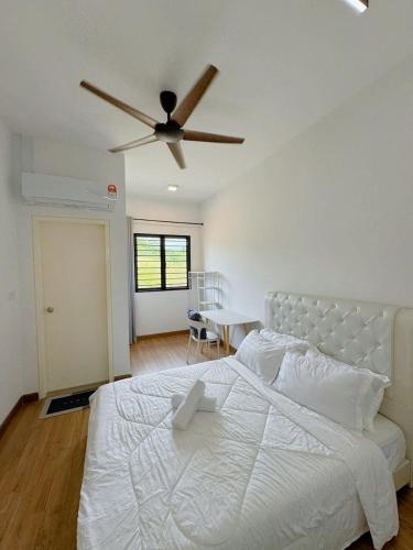 a bedroom with a white bed with a ceiling fan at 4R3B NEW Kajang 2 Double Storey - 12 pax in Semenyih