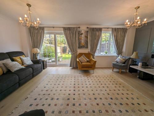 a living room with a couch and a chair at Spacious 4 Bed Gem near East Croydon Station in South Norwood