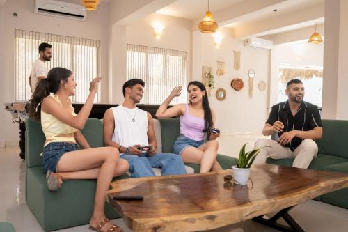 a group of people sitting on a couch at Voyage Zo Lonavala in Lonavala