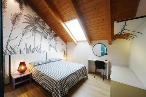 a bedroom with a bed and a desk and a window at Terrazza 72 - Deluxe Room & Breakfast in Agerola