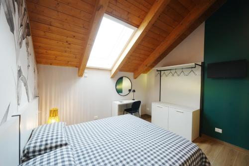 a bedroom with a bed with a checkered blanket at Terrazza 72 - Deluxe Room & Breakfast in Agerola