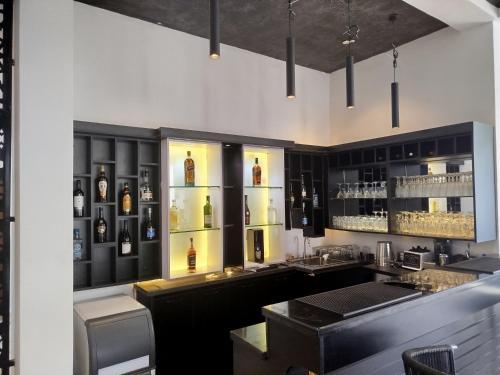 a bar with a lot of bottles of alcohol at The Stallion Abuja in Abuja