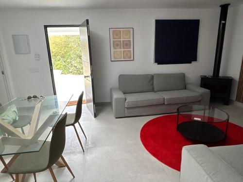 a living room with a couch and a glass table at Villa Marismas in Barbate