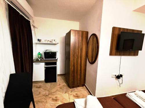 a living room with a television and a kitchen at Slimiza Suites in Sliema