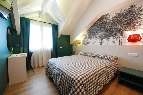 a bedroom with a bed with a checkered blanket at Terrazza 72 - Deluxe Room & Breakfast in Agerola