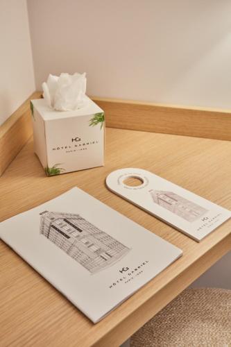 a table with a box of tissues and a napkin at Hotel Gabriel Issy Paris in Issy-les-Moulineaux