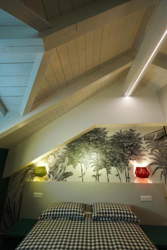 a bedroom with a mural of trees on the wall at Terrazza 72 - Deluxe Room & Breakfast in Agerola