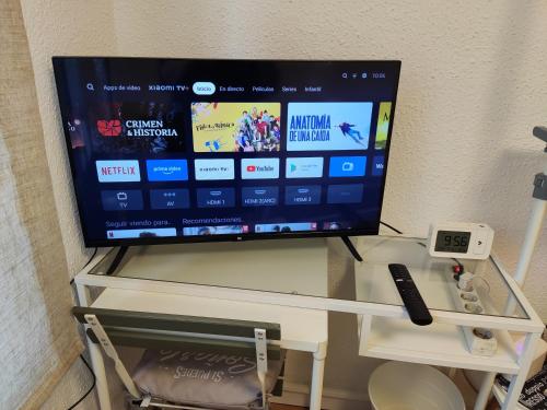 a flat screen tv sitting on top of a table at Rooms Villaverde in Madrid