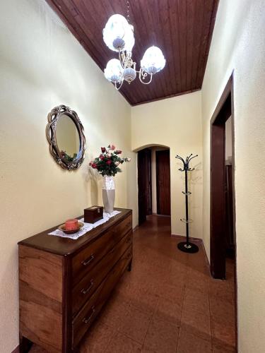 a room with a dresser and a mirror on the wall at All'Ombra del Campanile in Palizzi