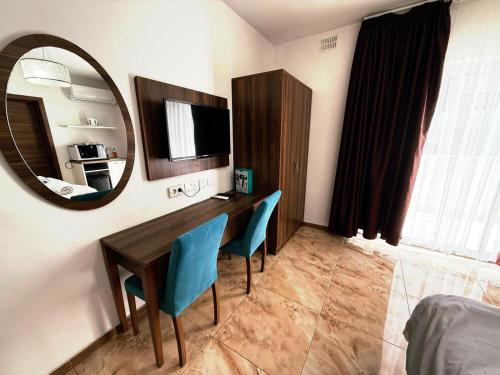 a room with a table and chairs and a mirror at Slimiza Suites in Sliema
