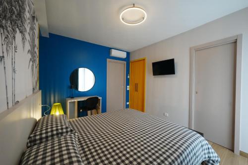 a bedroom with a bed and a blue wall at Terrazza 72 - Deluxe Room & Breakfast in Agerola