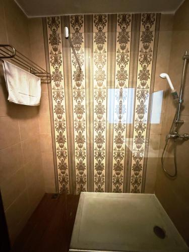 a bathroom with a shower with a shower curtain at Slimiza Suites in Sliema