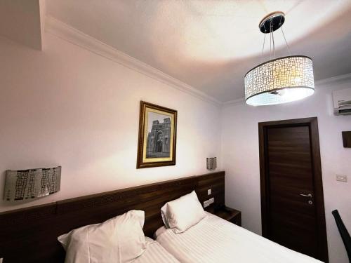 a bedroom with a bed and a chandelier at Slimiza Suites in Sliema