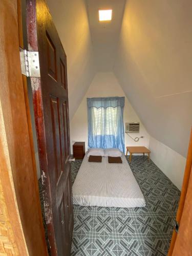 a bedroom with a bed in a attic at Monera Native Hut in San Juan