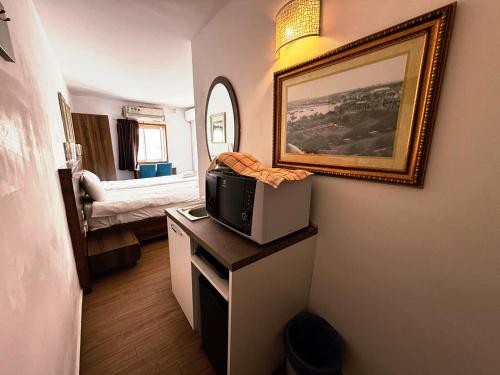a room with a tv on a table with a picture at Slimiza Suites in Sliema