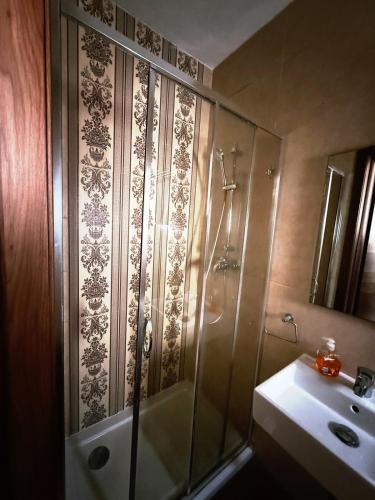 a bathroom with a shower and a sink at Slimiza Suites in Sliema