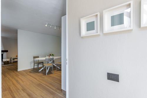 a room with a table and a dining room at ComoLake Apartments & Rooms in Cantù