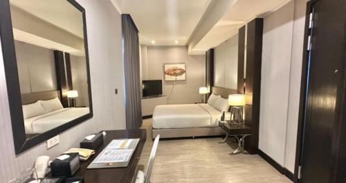 Cama o camas de una habitación en Le Charmé Suites - Subic