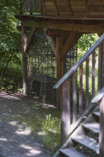 a bird cage sitting under a wooden deck at TREE HOUSE U Mravence in Jinačovice
