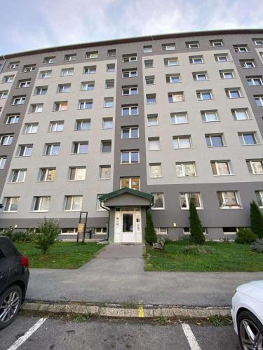 a large building with a white door in front of it at BardiHome in Bardejov