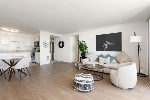 a living room with a couch and a table at The violet-Santa Monica highrise beach front&view in Los Angeles