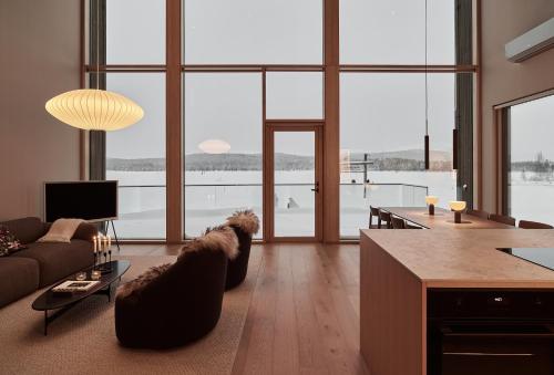 a living room with a dog laying on a couch at Stay North - The House of Northern Lights in Äkäslompolo