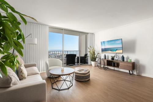 a living room with a couch and a table at The violet-Santa Monica highrise beach front&view in Los Angeles