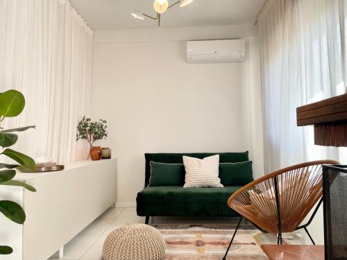 a living room with a green couch and a window at Rimini Smart Stay in Rimini