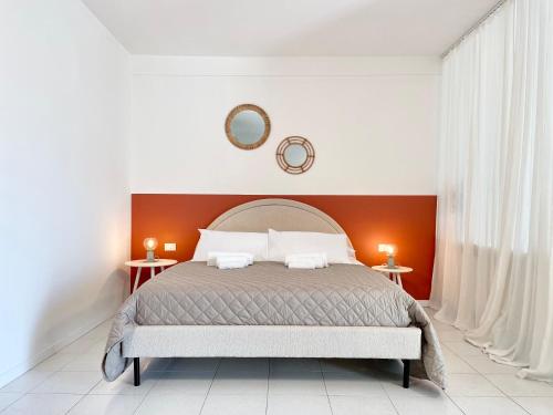 a bedroom with a large bed with two tables at Rimini Smart Stay in Rimini
