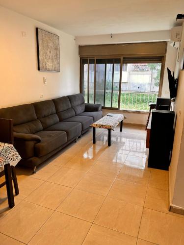 a living room with a couch and a table at Quiet House in Haifa