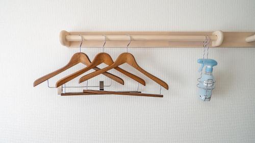 a group of wooden hangers hanging on a wall at Toyoko Inn Takamatsu Ekimae in Takamatsu