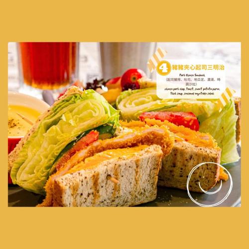 a sandwich with lettuce and tomatoes on a plate at West Hotel in Puli