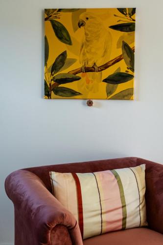 a brown leather couch with a yellow painting on the wall at Pension Landhaus- Frühstückspension im Brombachtal in Brombachtal