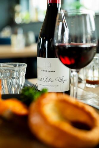 a bottle of red wine and a glass of bread at Hive Townhouse in Aberaeron