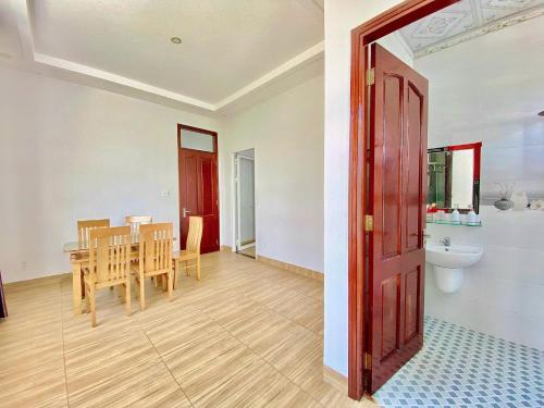 a kitchen and dining room with a table and a bathroom at Serina Villa Pool Beach in Vung Tau